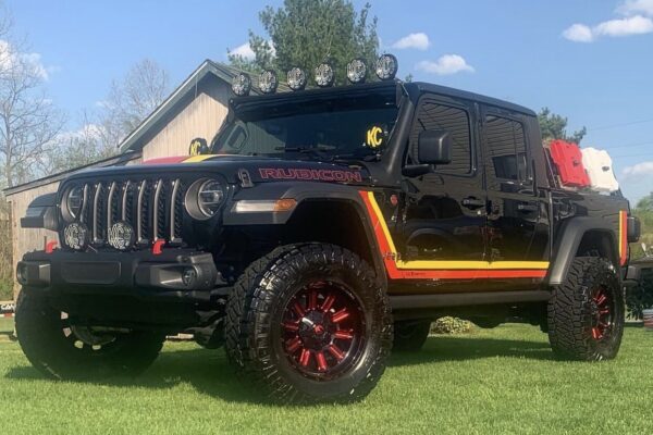 A Jeep Gladiator with retro Scramber style graphics