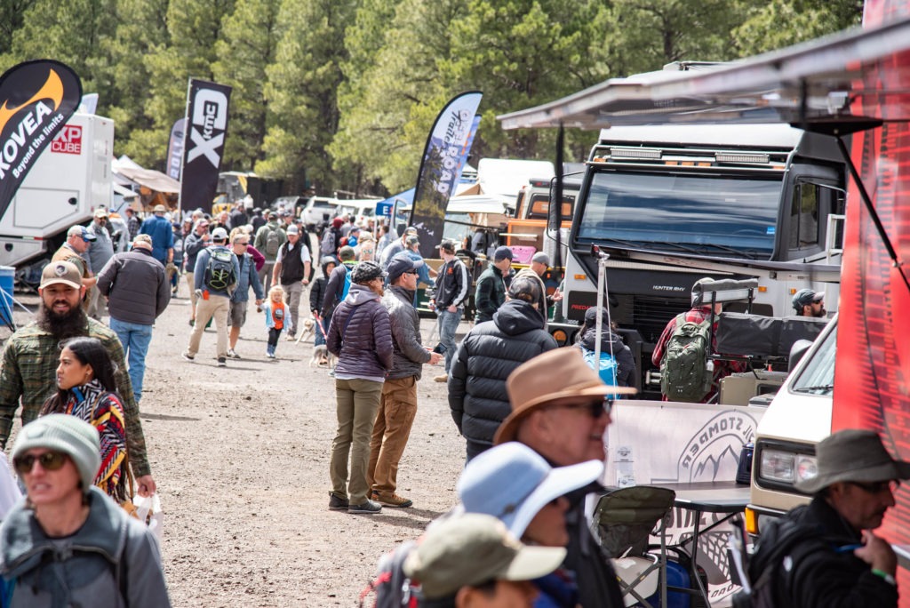 Attendees walking the exhibitor area at Overland Expo.