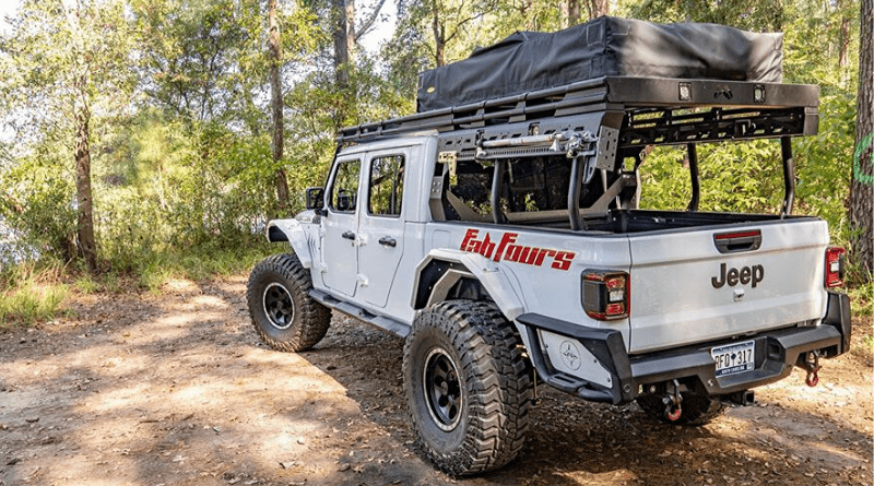 Fab Fours Jeep Gladiator parked in a clearing in the woods.