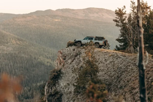 Toyota Tacoma perched atop a mountain viewpoint.