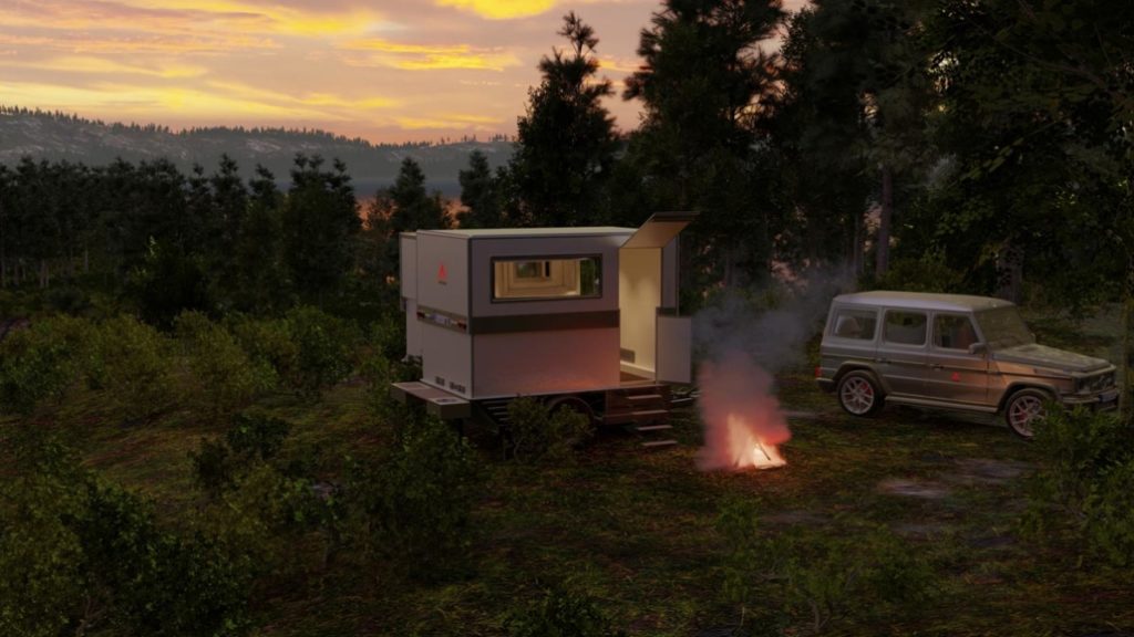 Night falling on the ICC Offroad Flex Camp in the forest near a campfire.