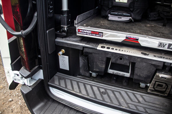 DECKED Drawer System with a CargoGlide slide mounted on top of it in the bed of a truck.