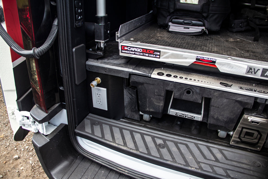 DECKED Drawer System with a CargoGlide slide mounted on top of it in the bed of a truck.