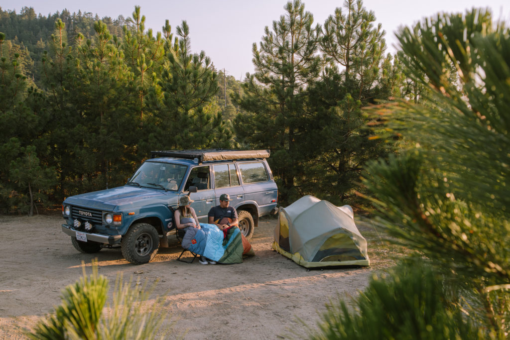 Rev Tent deployed on the ground next to a Land Cruiser