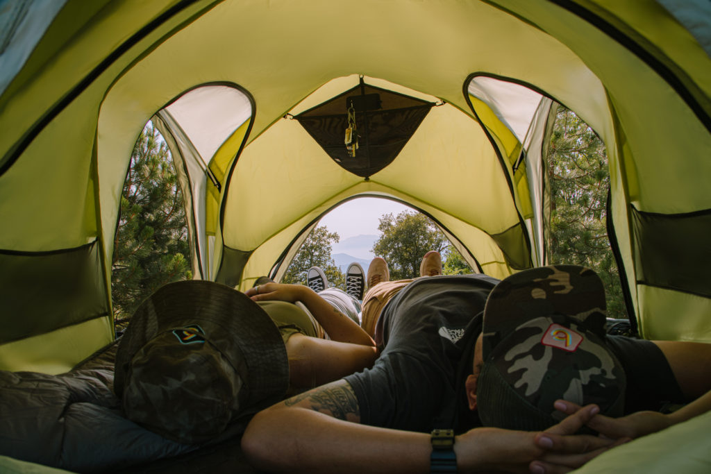 Couple relaxing in the Rev Tent in the forest