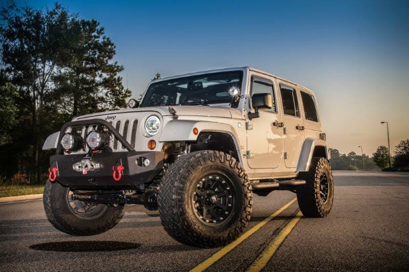 Jeep JK parked on the street at sunset, showing off the Vision X 7" VX Series Jeep JK LED Headlight Kit.