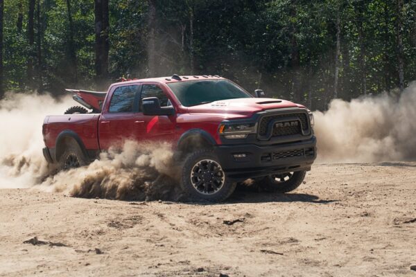 The 2023 Ram 2500 Heavy Duty Rebel kicking up some dust on an offroad track.