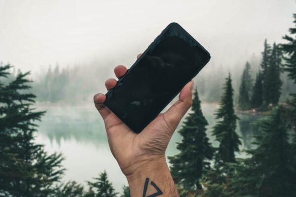 holding up iphone in wilderness